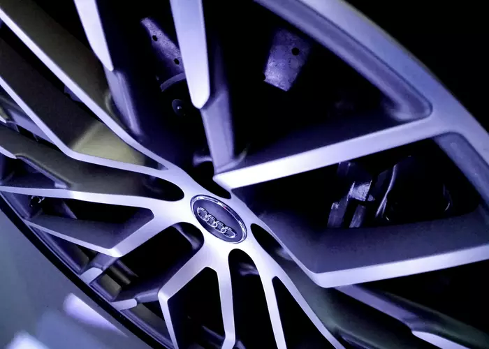 Sleek, silver alloy wheel with intricate spoke design.